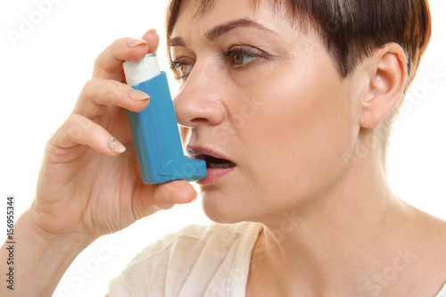 Adult woman using inhaler o...