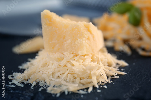 Slate plate with grated cheese on table