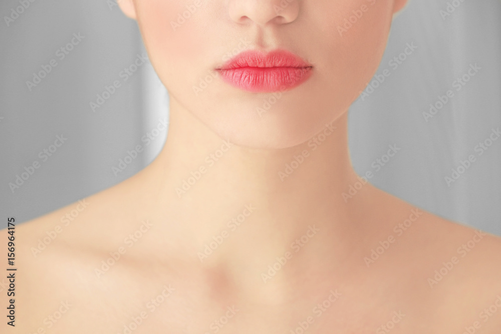 Beautiful young woman on blurred background, closeup