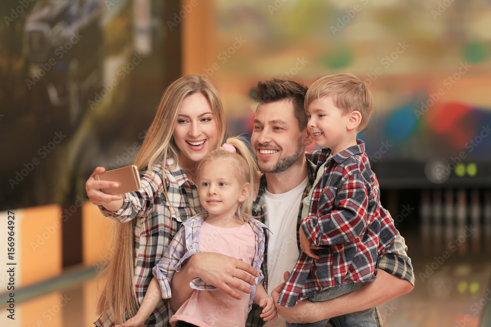 Fototapeta premium Family taking selfie at bowling club