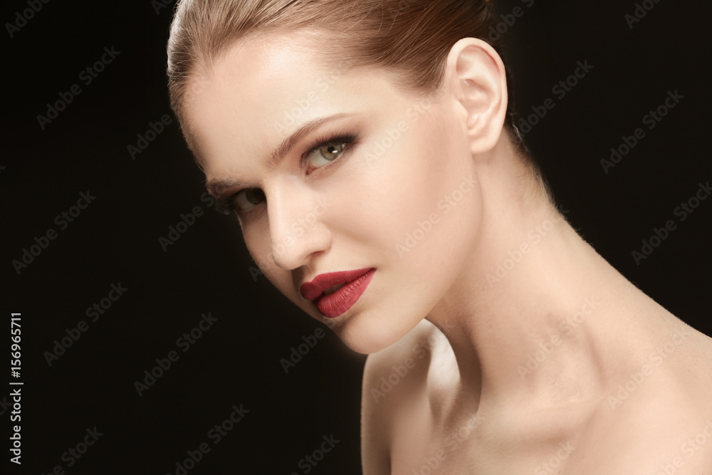 Beautiful young woman on dark background Beautiful young woman on dark background