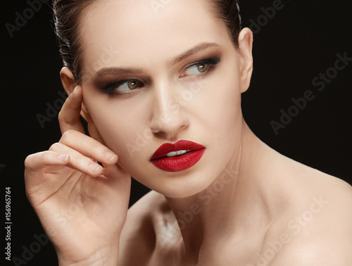Beautiful young woman on dark background  closeup