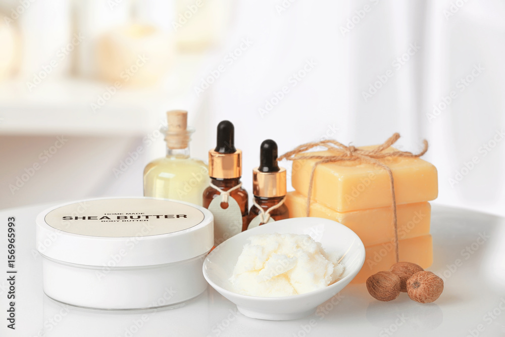Composition of Shea butter with cosmetic products on table