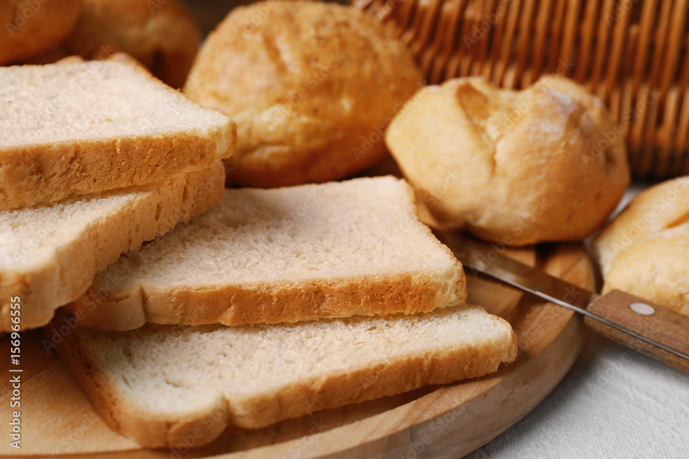 Delicious sliced bread on wooden cutting board Delicious sliced bread on wooden cutting board