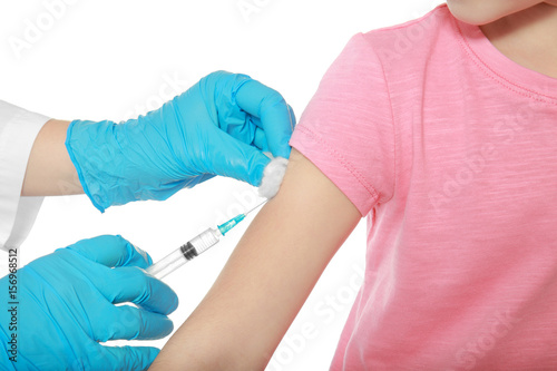Vaccination concept. Female doctor vaccinating cute little girl on white background, closeup