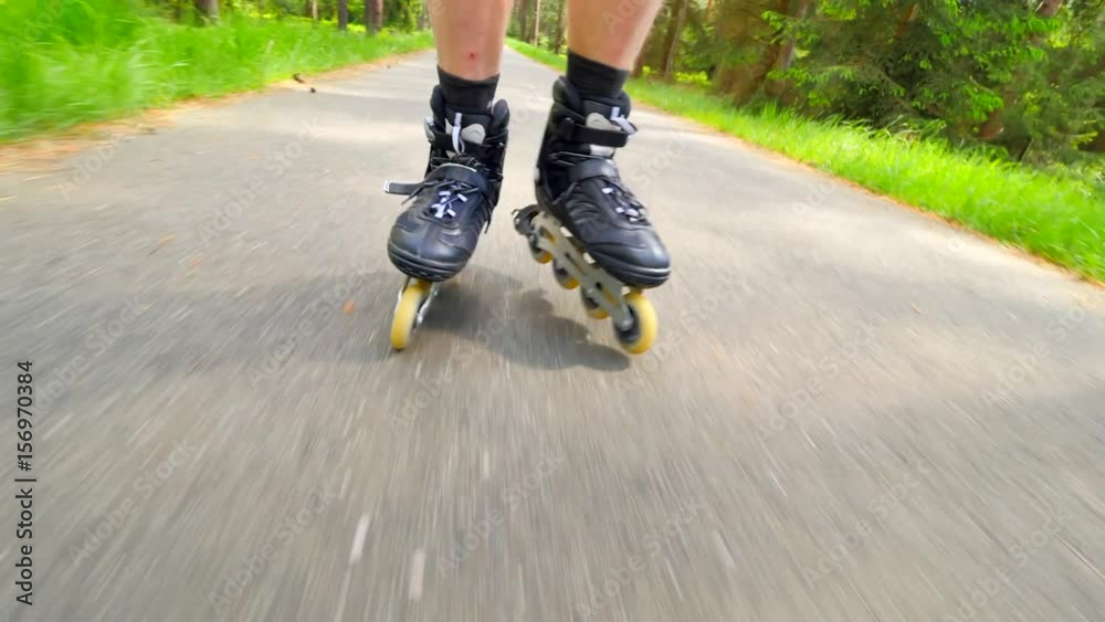 Outdoor shuffle inline skating. Mans legs roller skating on forest