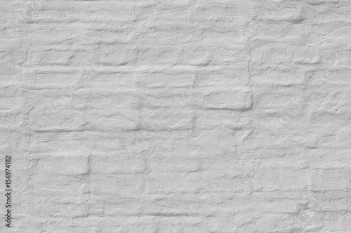 Whitewash painted old brick wall with plaster texture. Background for text or image. 