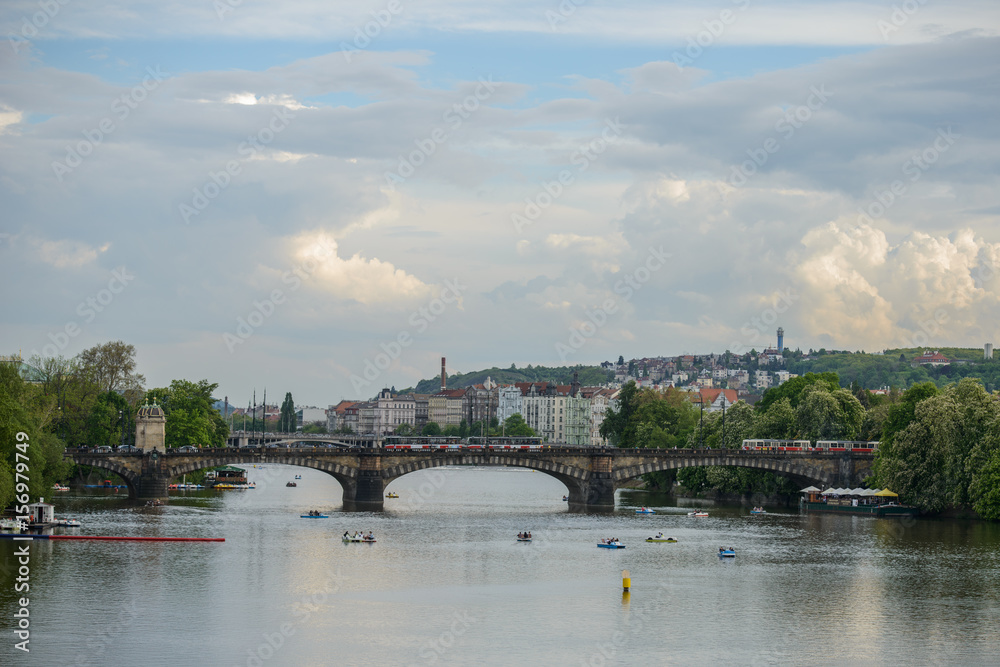 Obraz premium PRAGUE, CZECH REPUBLIC - 12 MAY 2017: View of the Vltava River with the pleasure boat and the Legia Bridge (Most Legii)