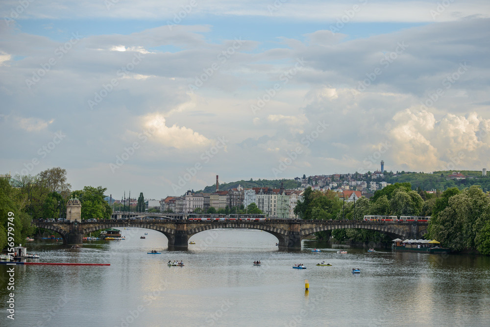 PRAGUE, CZECH REPUBLIC - 12 MAY 2017: View of the Vltava River with the pleasure boat and the Legia Bridge (Most Legii)
