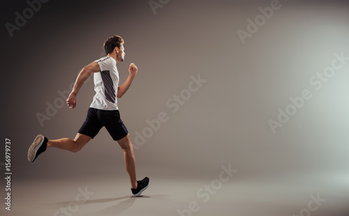 Young, active jogger running - isolated