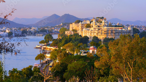 Panorama view of  Udaipur City Palace, island and tourist boat on lake Pichola in the evening, on sunset, Udaipur, Rajasthan, India photo