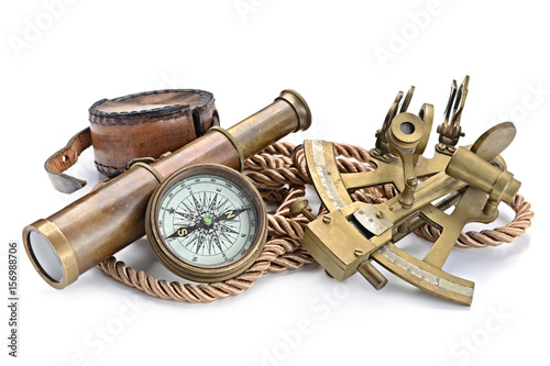 compass,sextant and spyglass on the white