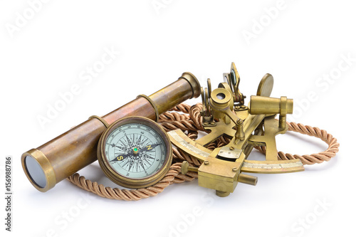 compass,sextant and spyglass on the white