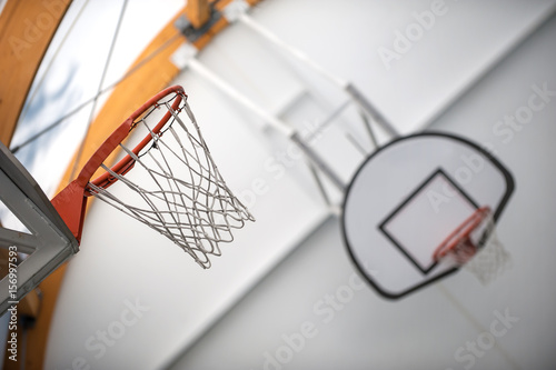 Two basketball hoops in sport school gym hall © guruXOX