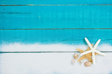 Teal blue beach sign with seashell and sand border