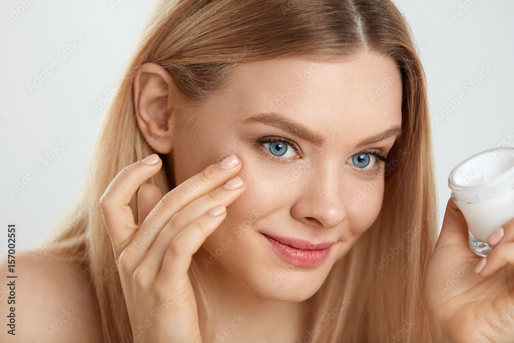 Beauty Face Care. Young Female Model Putting Cream On Eye Skin Beauty Face Care. Young Female Model Putting Cream On Eye Skin