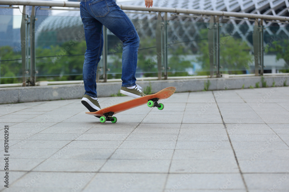 young skateboarder legs practicing at skatepark young skateboarder legs practicing at skatepark