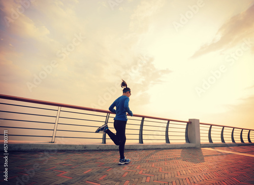 Healthy lifestyle young woman running at seaside