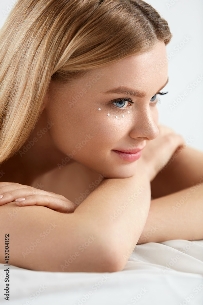 Beauty Cosmetics. Woman With Drops Of Eye Skin Cream On Skin Beauty Cosmetics. Woman With Drops Of Eye Skin Cream On Skin