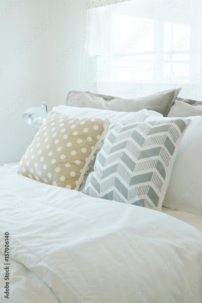 Yellow and green pillow on bed in pastel interior bedroom