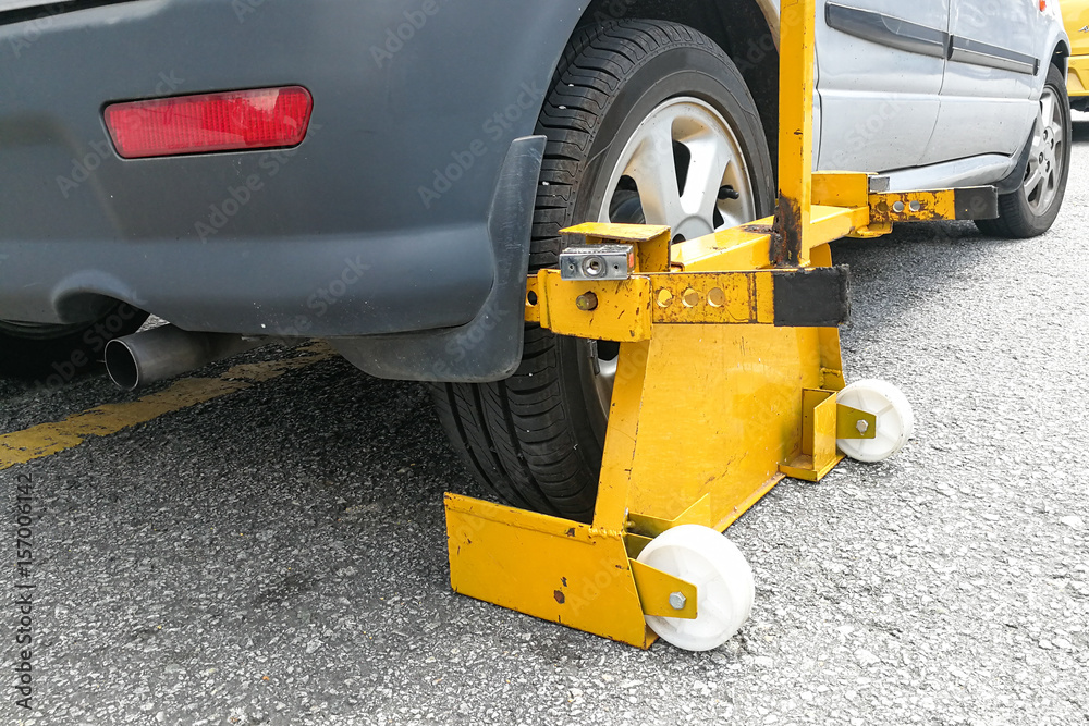 Car wheel clamp on street for illegal parking Car wheel clamp on street for illegal parking