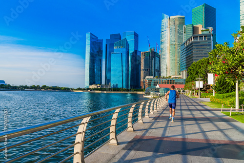 Photography Healthy man running exercise in the morning in Marina Bay Sand park, Singapore