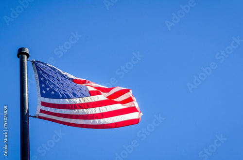 American Flag Wavering Against Blue Sky