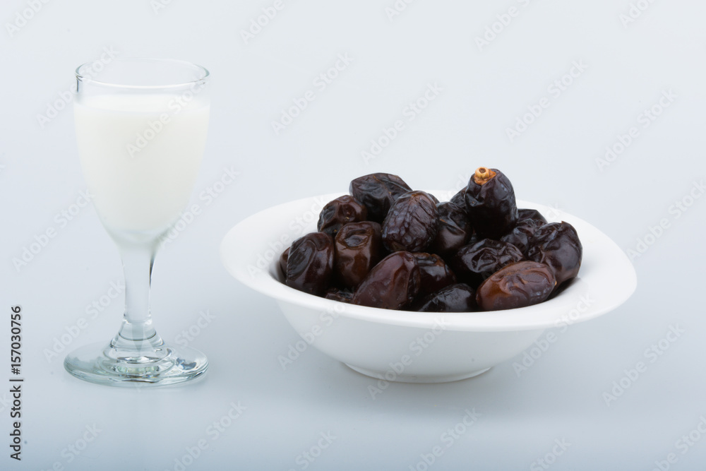 Isolated dates with milk in a plate Isolated dates with milk in a plate