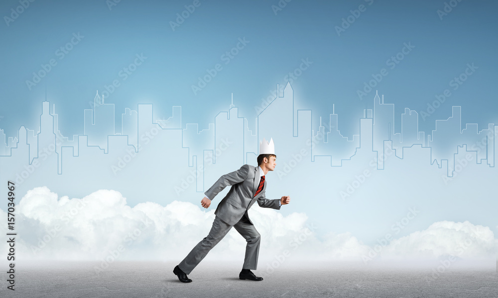 King businessman in elegant suit running and blue cityscape silhouette at background King businessman in elegant suit running and blue cityscape silhouette at background