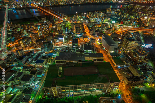 Aerial view of Osaka City Central business and Yodo River with its bridges at night. Osaka Skyline from Kita ward of Japan. Osaka is Japan's third largest city by population after Tokyo and Yokohama.