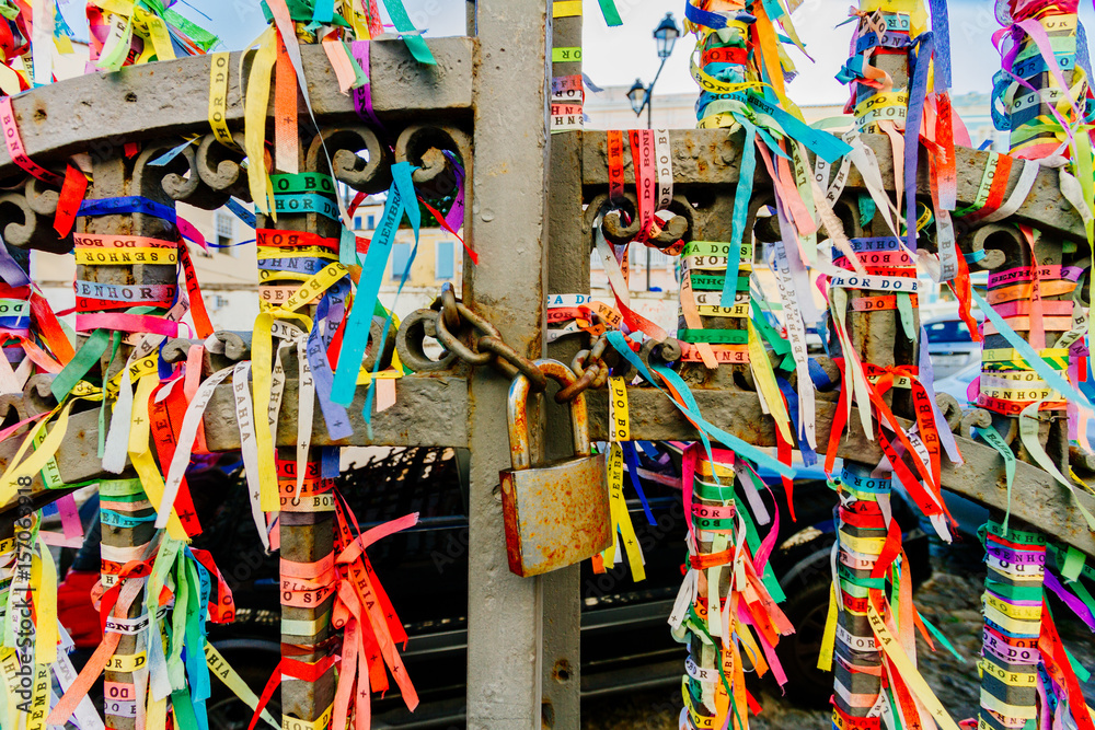 Colorful fabric ribbons (Lembranca do Senhor do Bonfim) tied in a grating in Salvador, Brazil