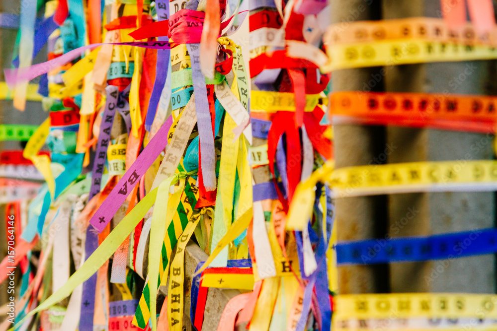 Colorful fabric ribbons (Lembranca do Senhor do Bonfim) tied in a grating in Salvador, Brazil