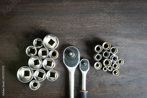 ratchet wrench lying on wooden table