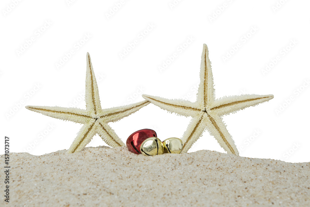 Starfishes and christmas bells on sand Starfishes and christmas bells on sand