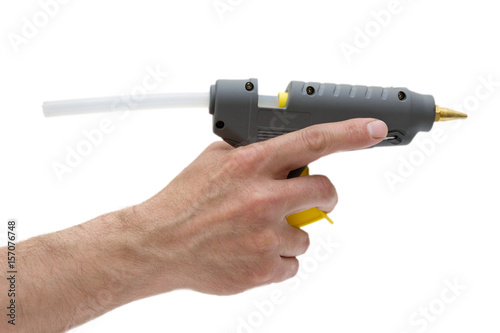 Glue gun in man hand isolated.Handmade using,popular device.