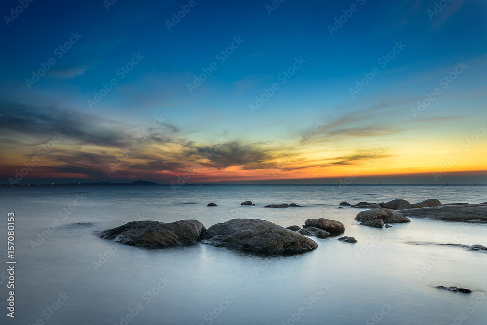 Rocks at sea side with sunset sky