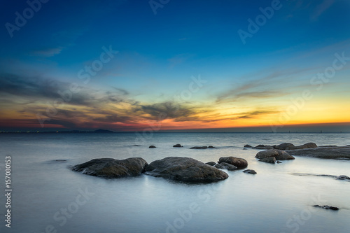 Rocks at sea side with sunset sky