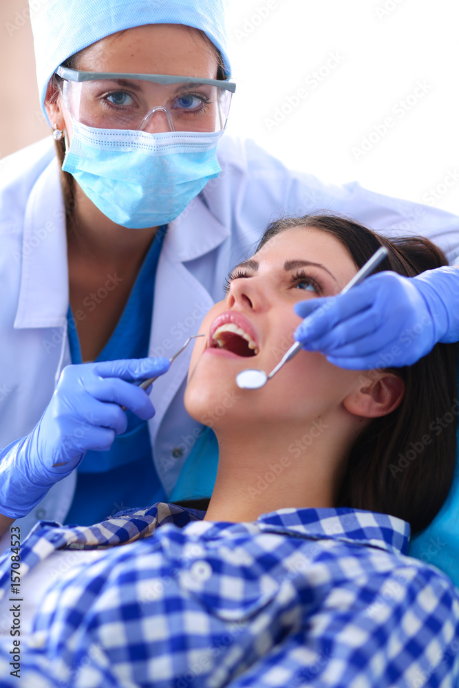 Woman dentist working at her patients teeth Woman dentist working at her patients teeth