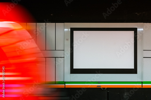 Fototapeta Naklejka Na Ścianę i Meble -  Train Station Blank Advertisement Motion Blur Passing Carriage