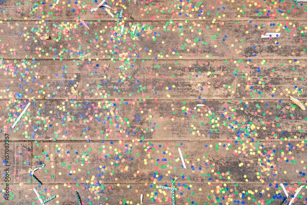 Wooden background with party confetti. festive confetti.