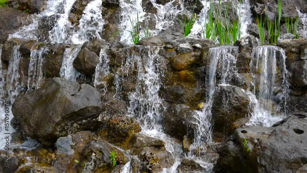 Amazing waterfall with rocks and green grass. Amazing waterfall with rocks and green grass.