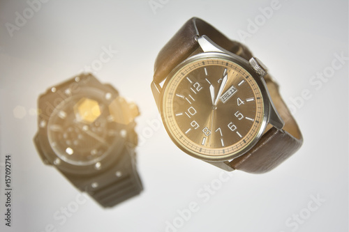 Wrist watches. Men's Swiss mechanical wrist watches, isolated on white background. Men's luxury wristwatches floating in the air. Black and brown. Leather and steel watches.