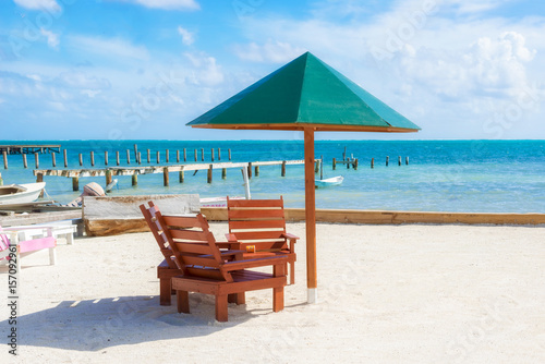 Umbrella and chairs on the beach in Caye Caulker, Belize.