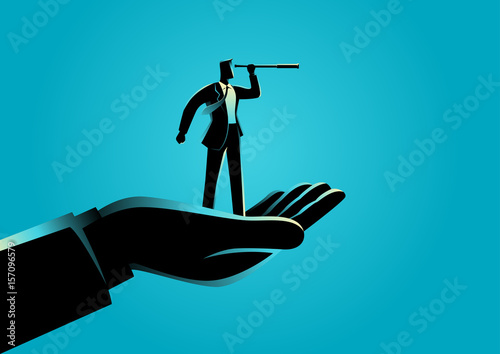 Hand holding a businessman using telescope