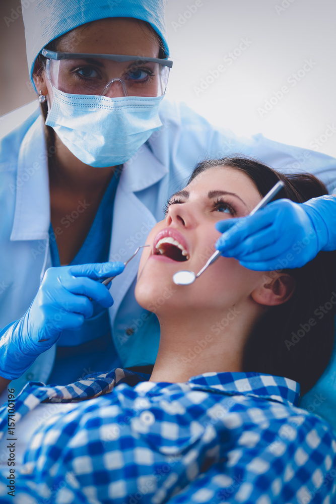 Woman dentist working at her patients teeth Woman dentist working at her patients teeth