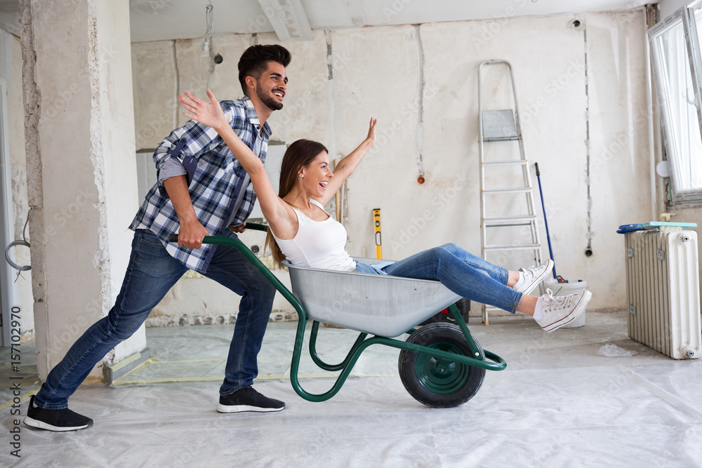 © didesign - Loving couple is having fun while they are renovating house