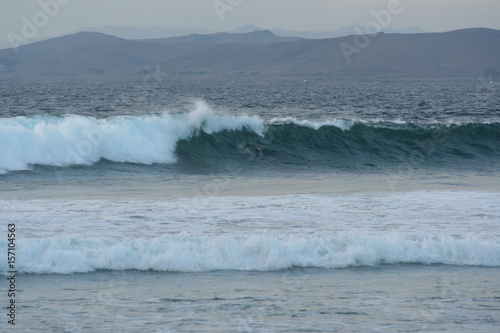 Duck diving surfer