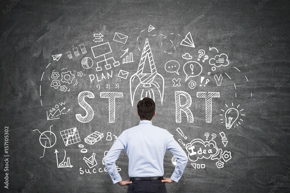 Businessman looking at start up sketch Businessman looking at start up sketch