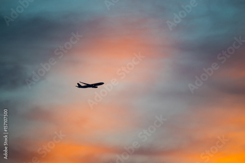Airplane flying during majestic sunset