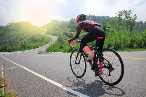women cycling mountain road bike in the morning